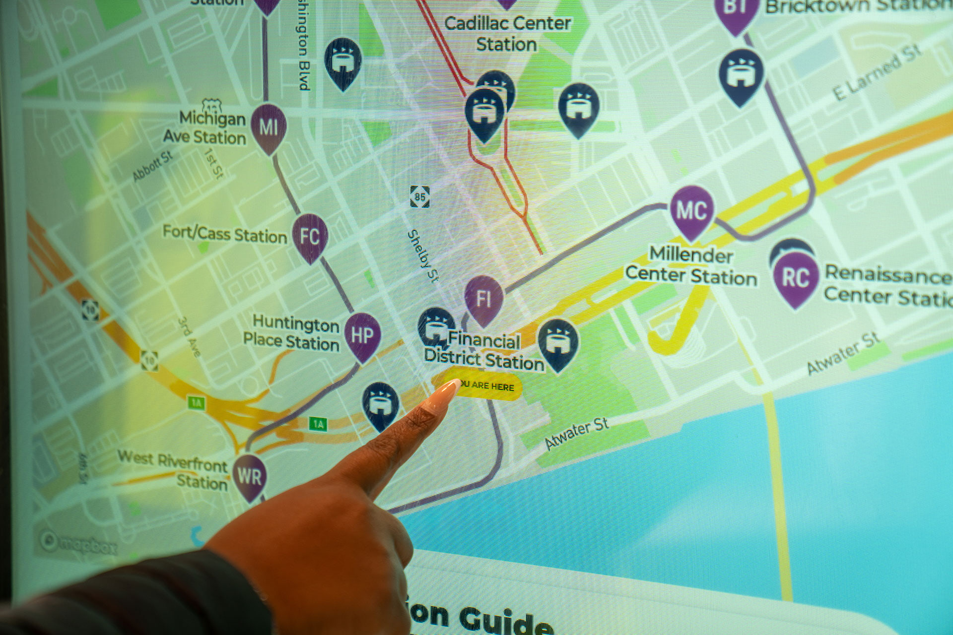 A woman points at a map.