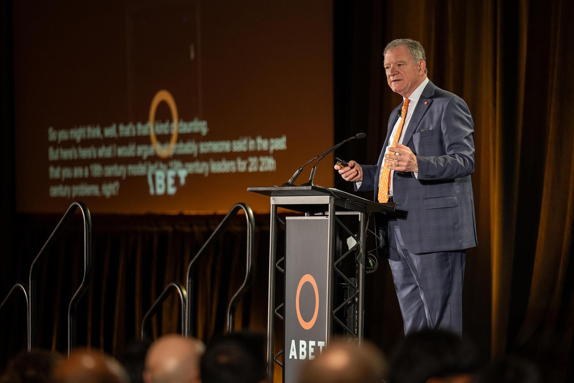 A person delivers remarks at a podium