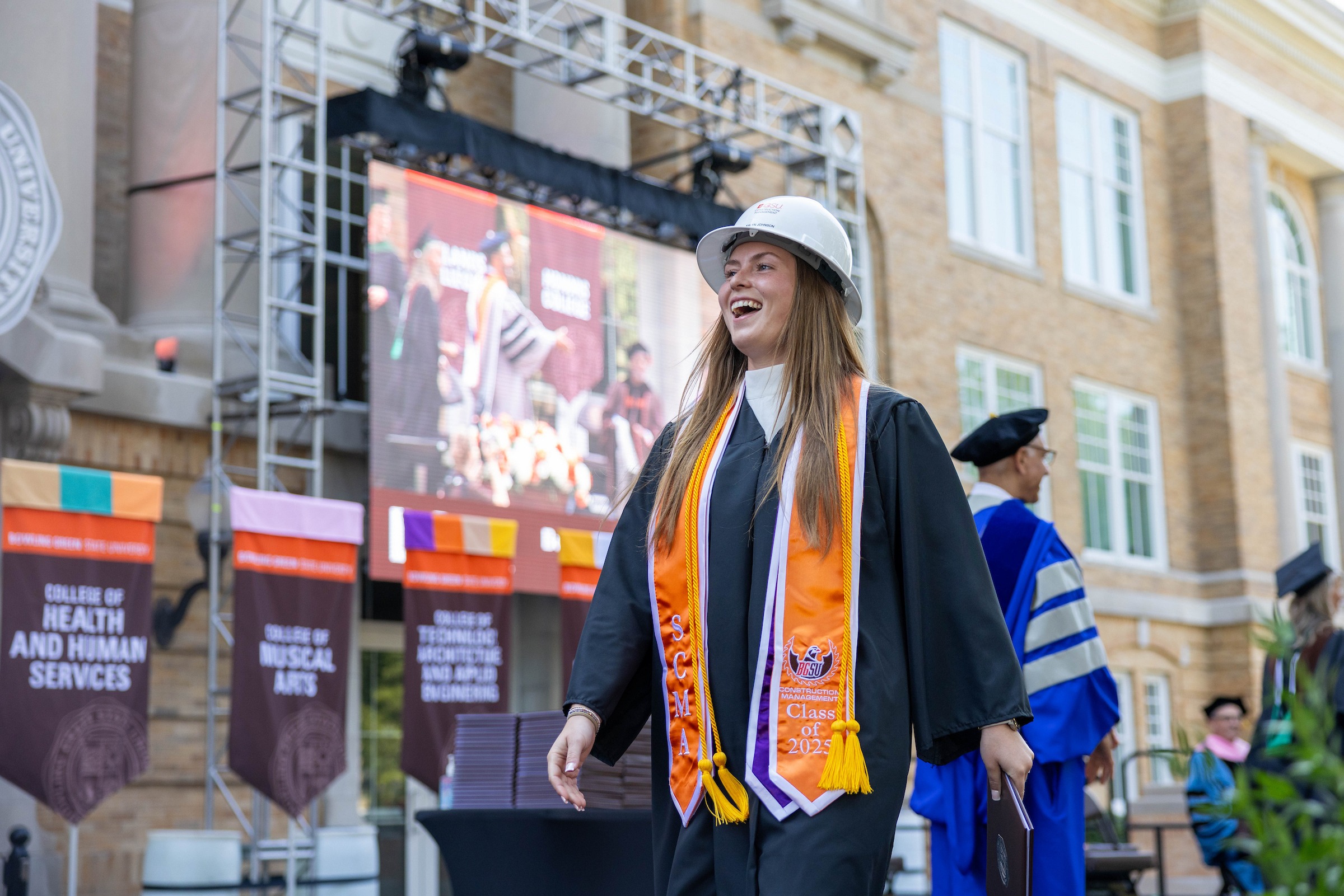 A construction management graduate crosses the stage