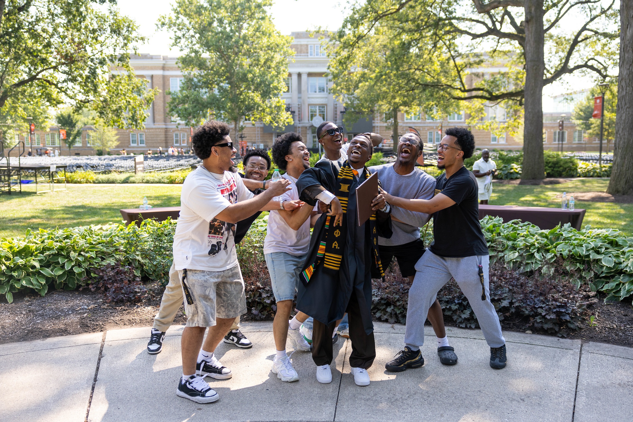 A graduate celebrates with supporters