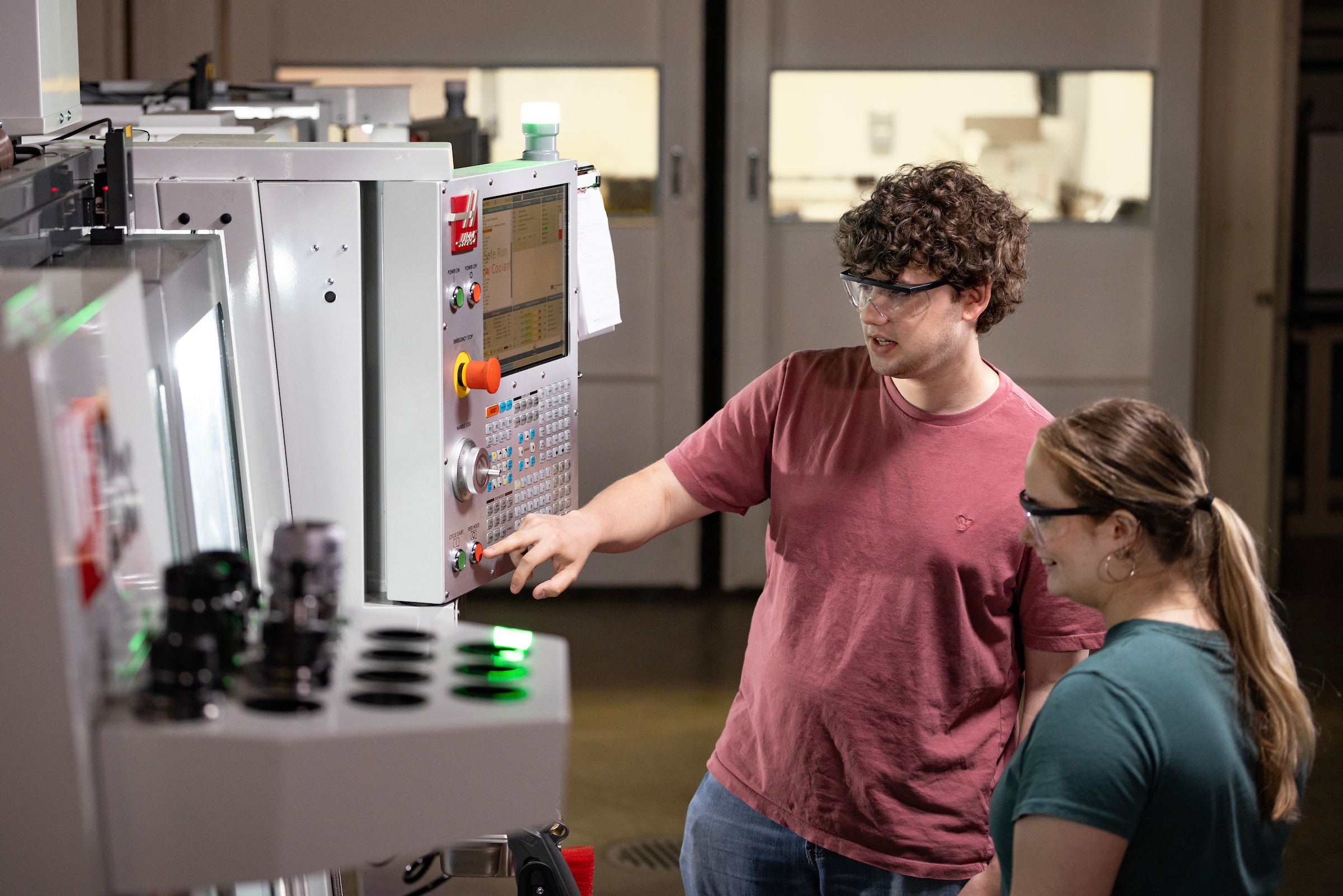 Two students work on engineering equipment in a BGSU lab