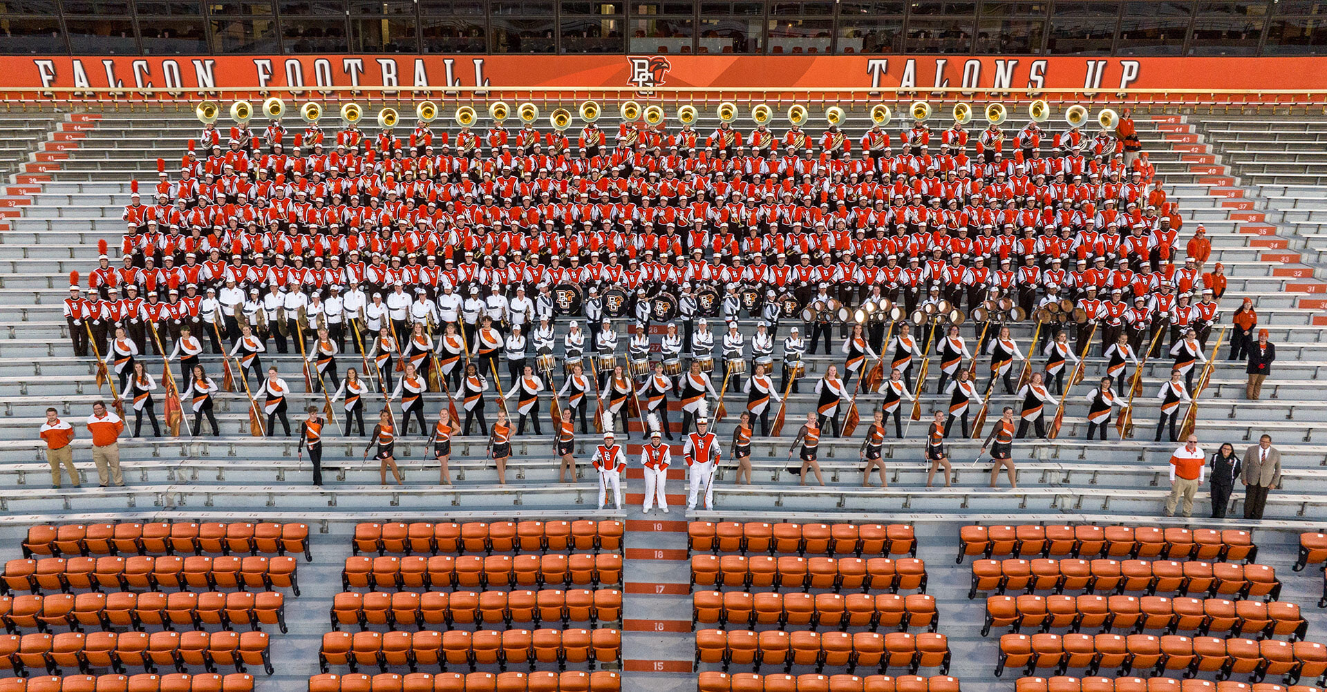 The BGSU Falcon Marching Band posing for a photo inside Doyt L. Perry Stadium.