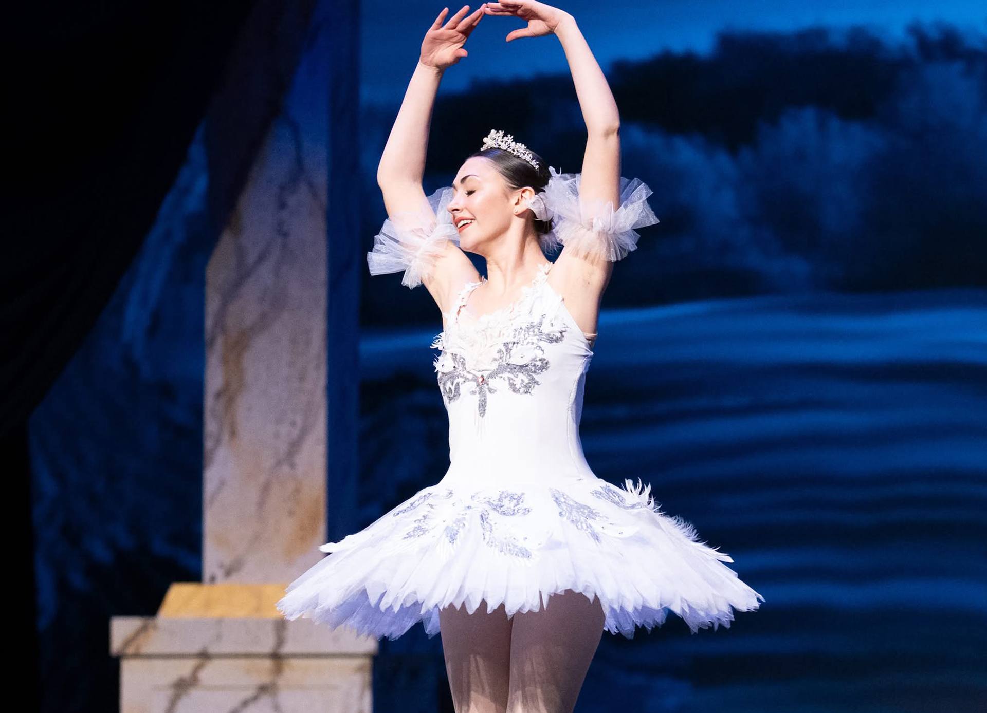 A person performs as a ballerina in a musical.