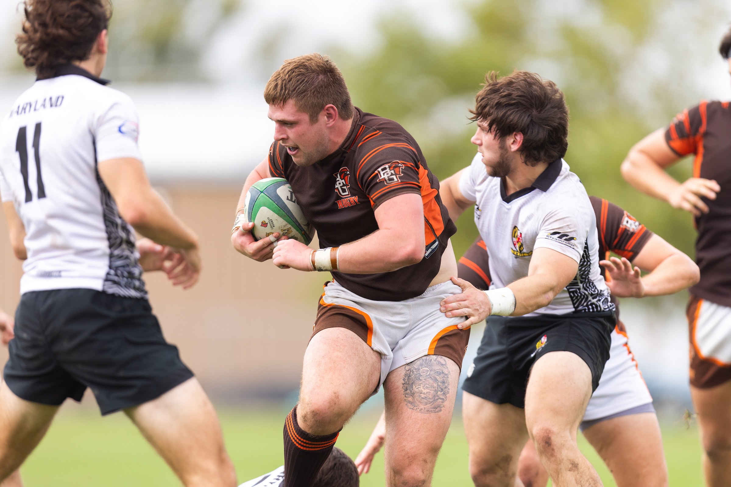 A BGSU player carries the ball during a rugby match