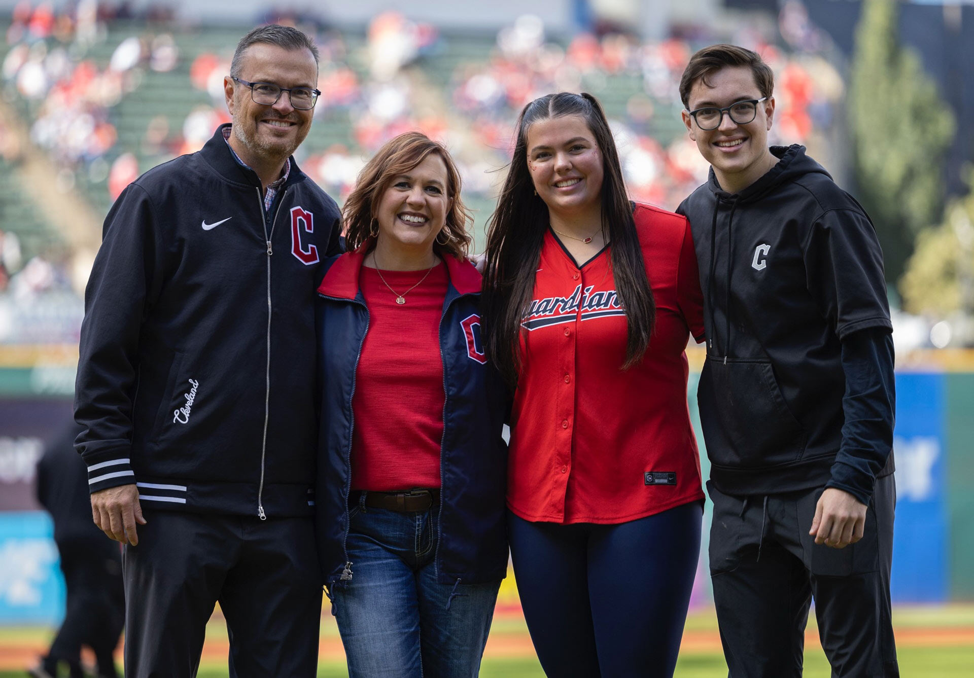 A family poses for a photo at the Cleveland Guardians' stadium
