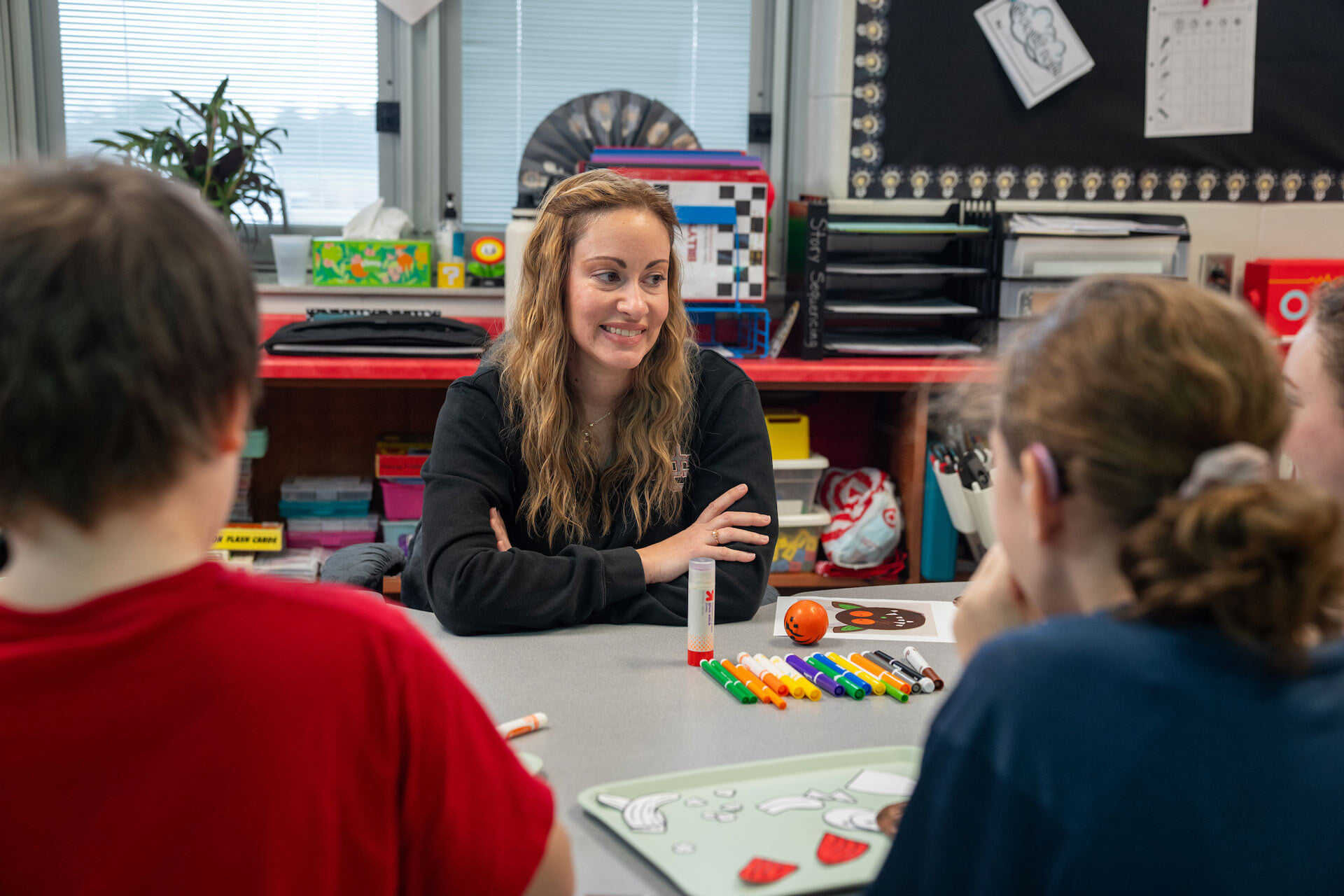 A teacher talks with students.