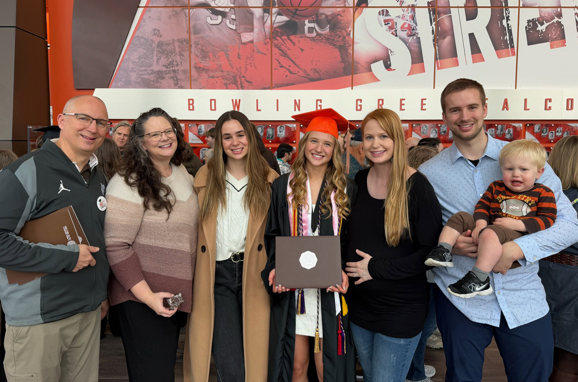 A family poses for a graduation photo. 