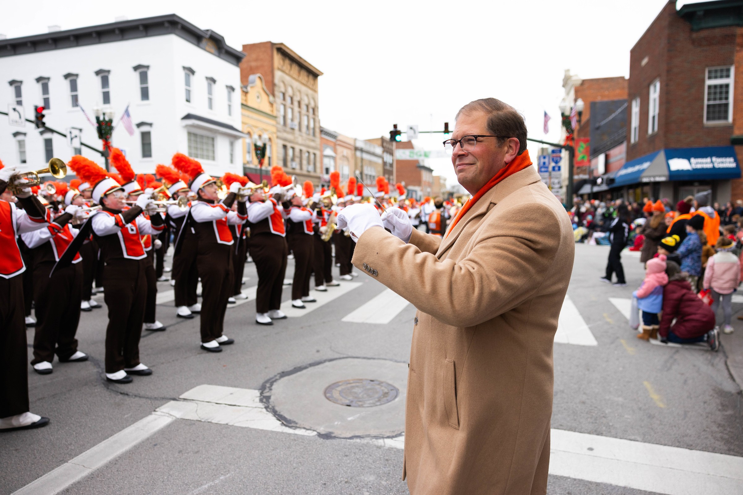 Professor and Director of Marching and Athletic Bands Jon Waters directs the band at the 2024 BG Holiday Parade.