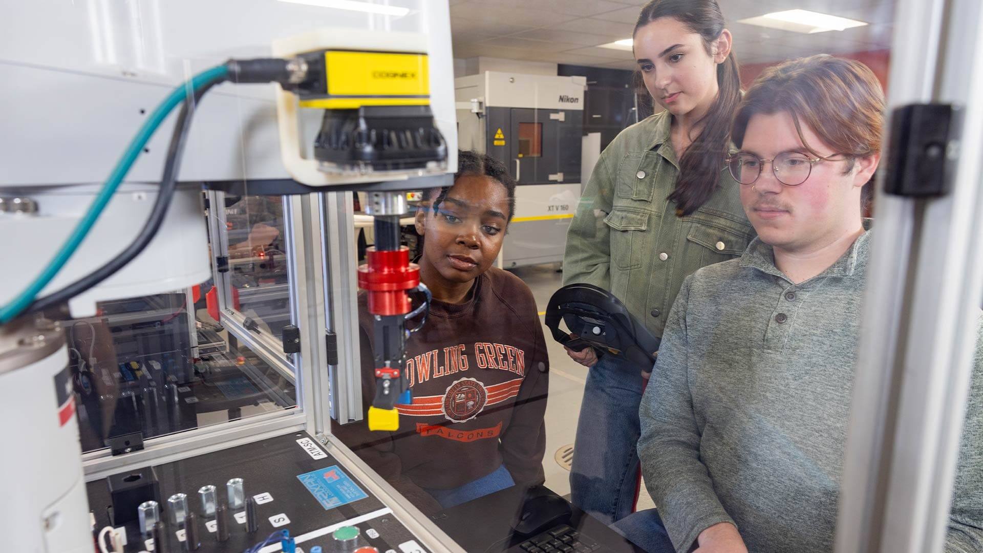 Students work with robotics equipment.