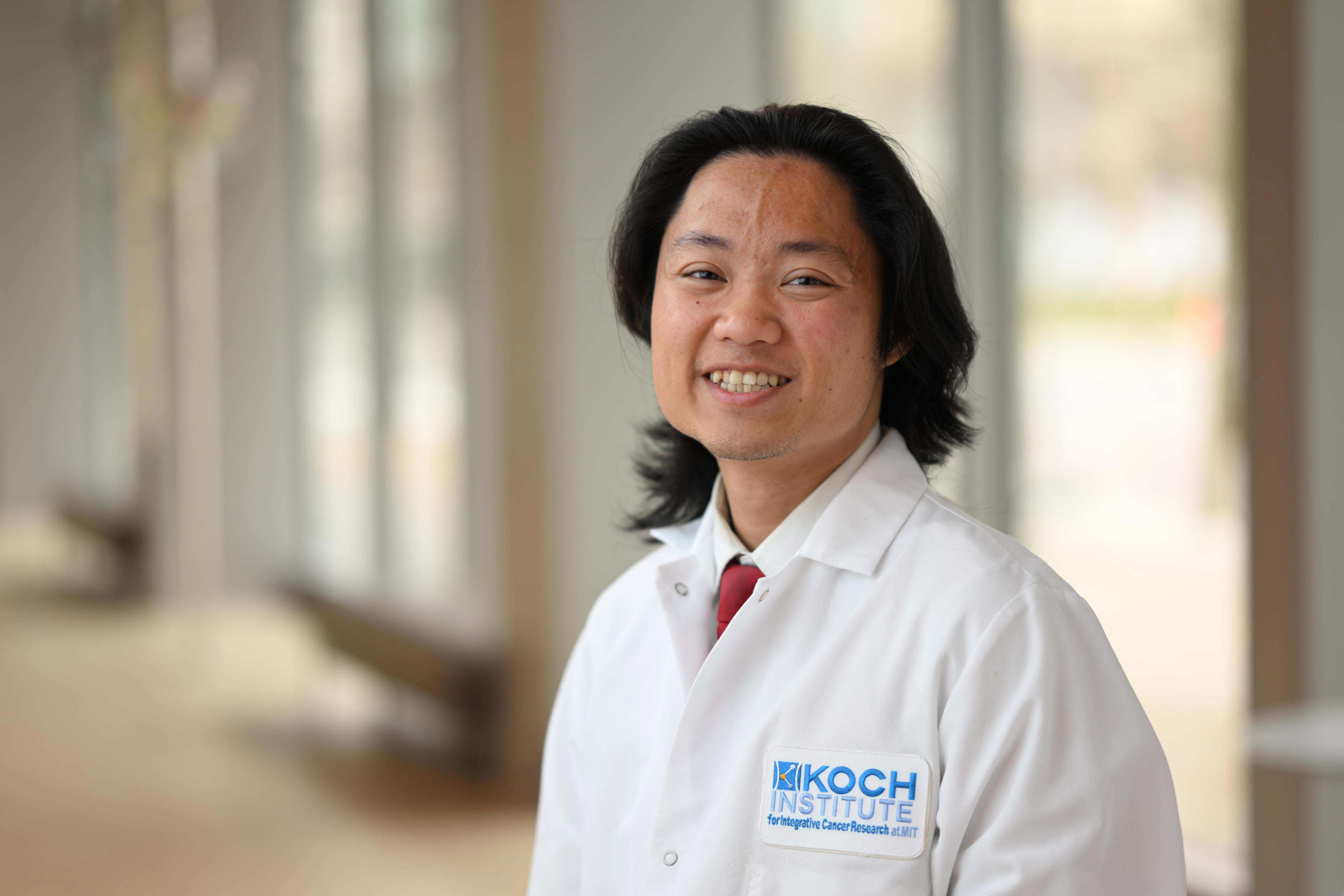 A person wearing a white MIT lab coat