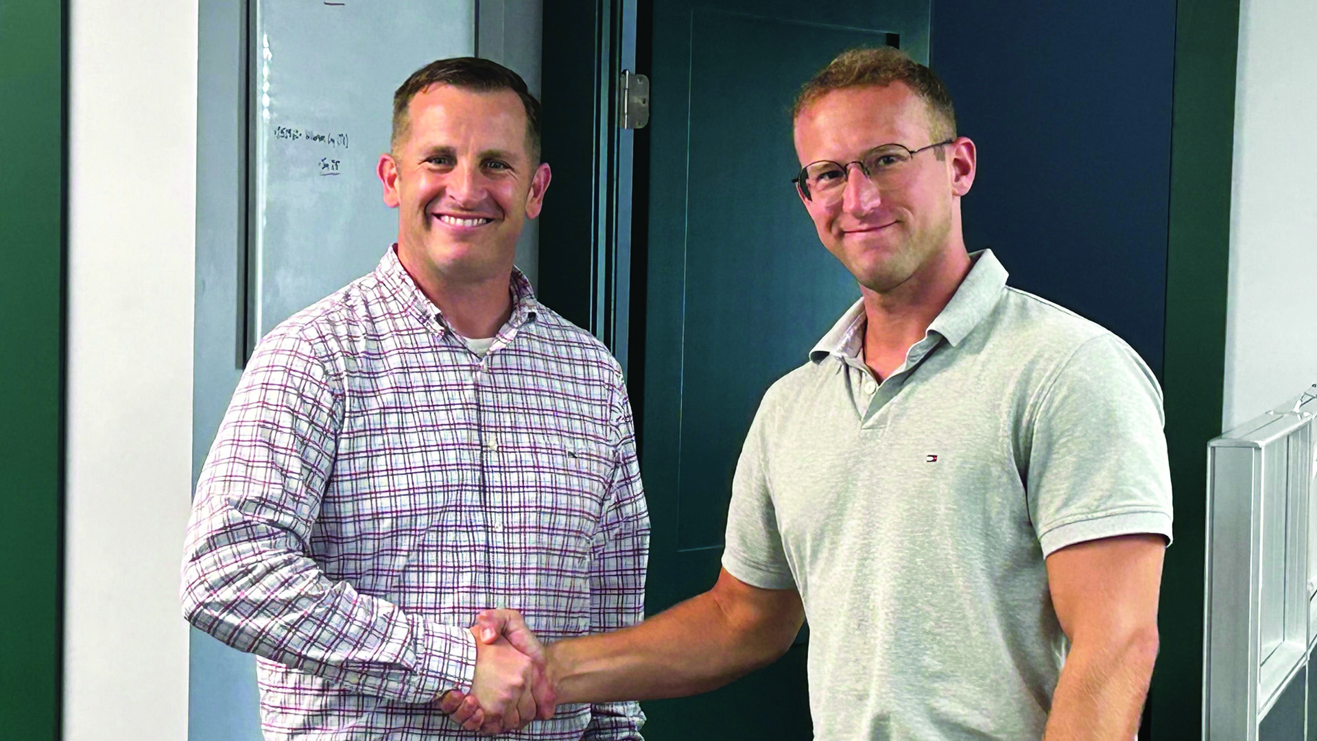 Two people shake hands.