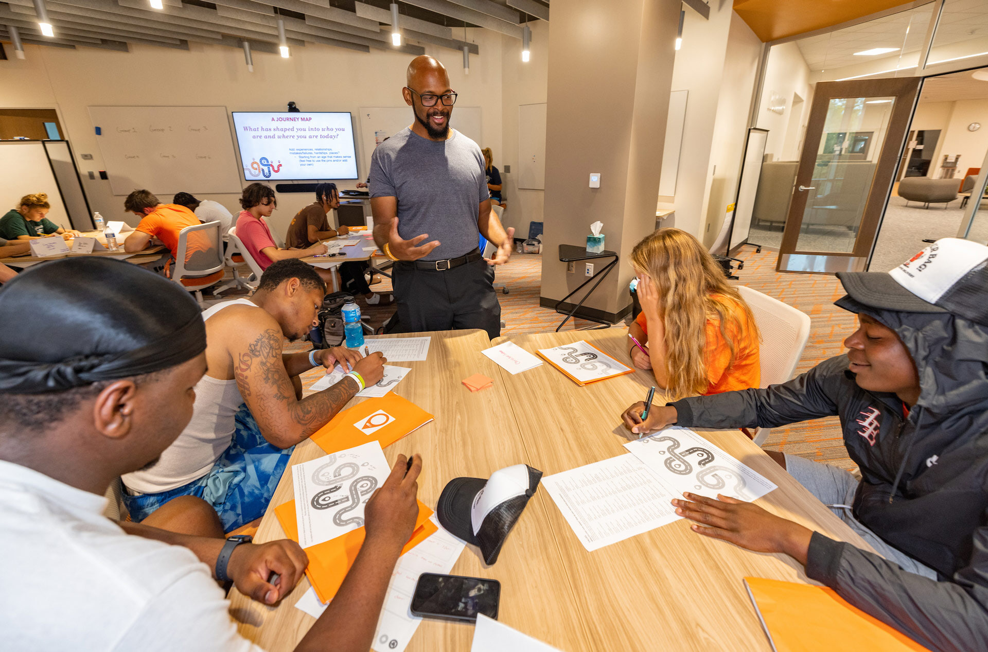 An instructor works with student athletes