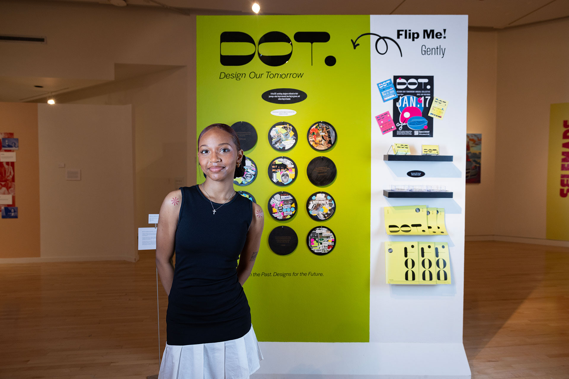 A person stands in front of art display