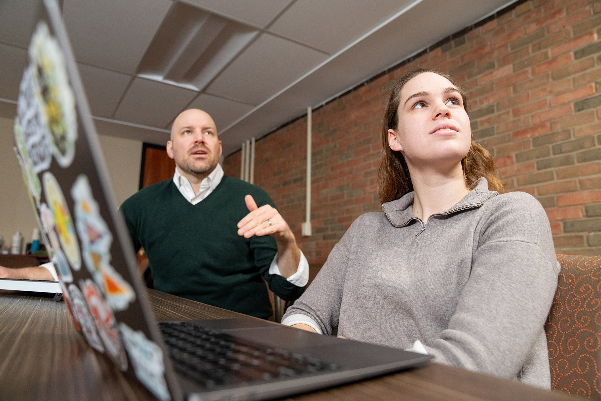Two people view data on a screen