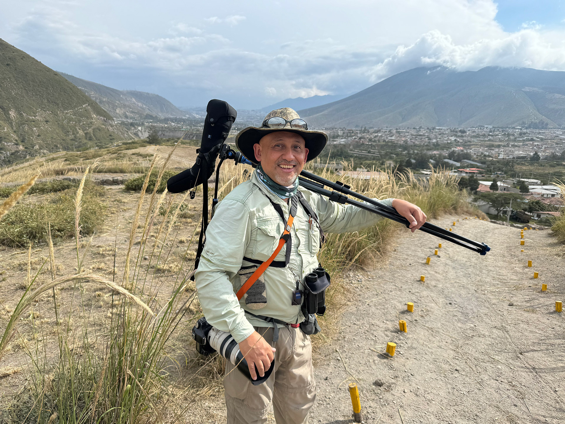 A man stands with a camera