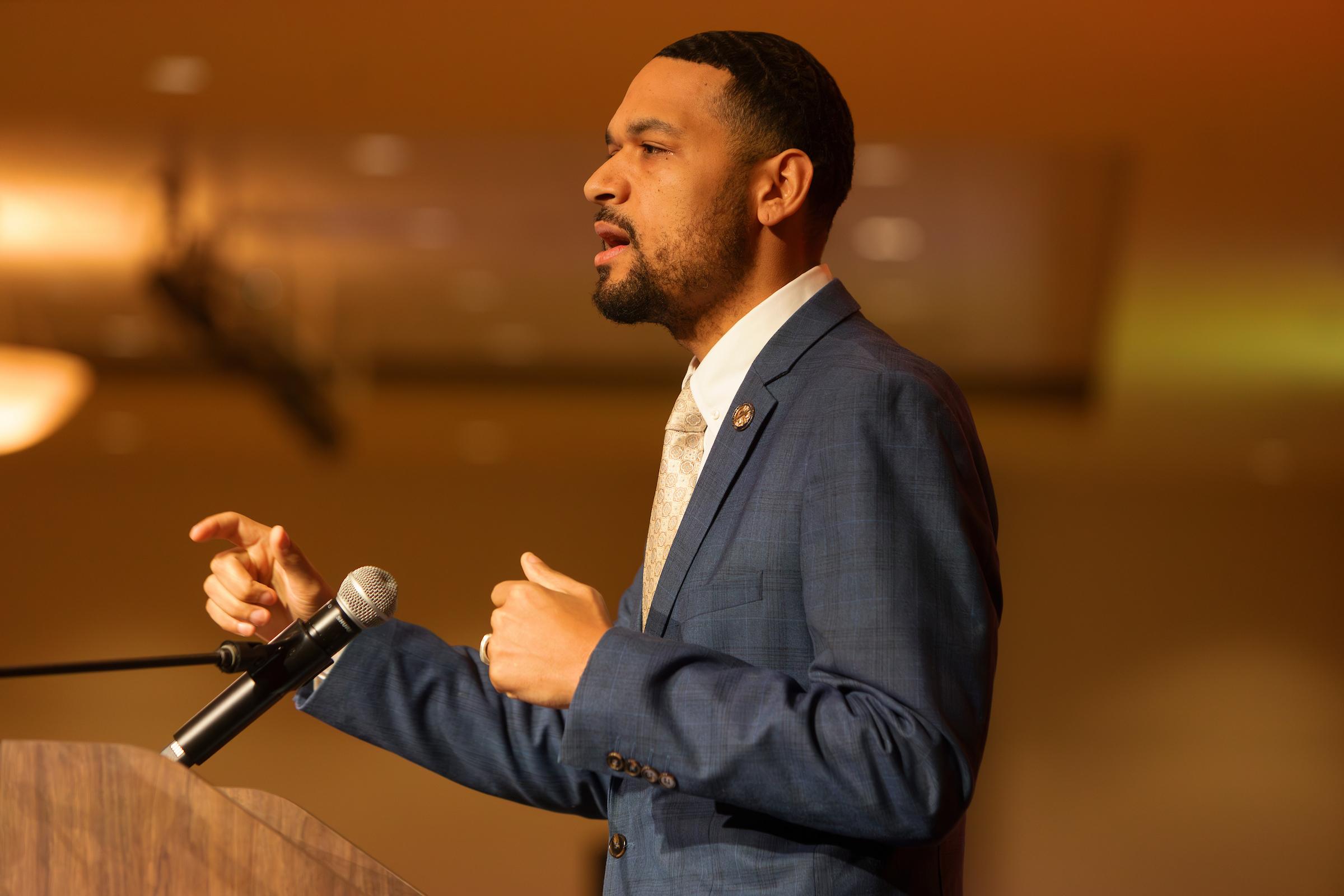 A person speaks at a podium.
