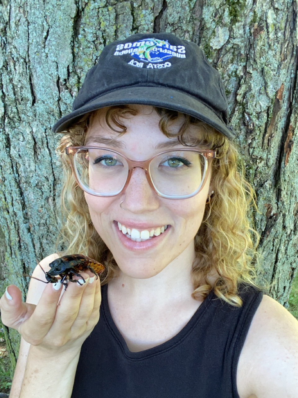 A scientist holds a bug.