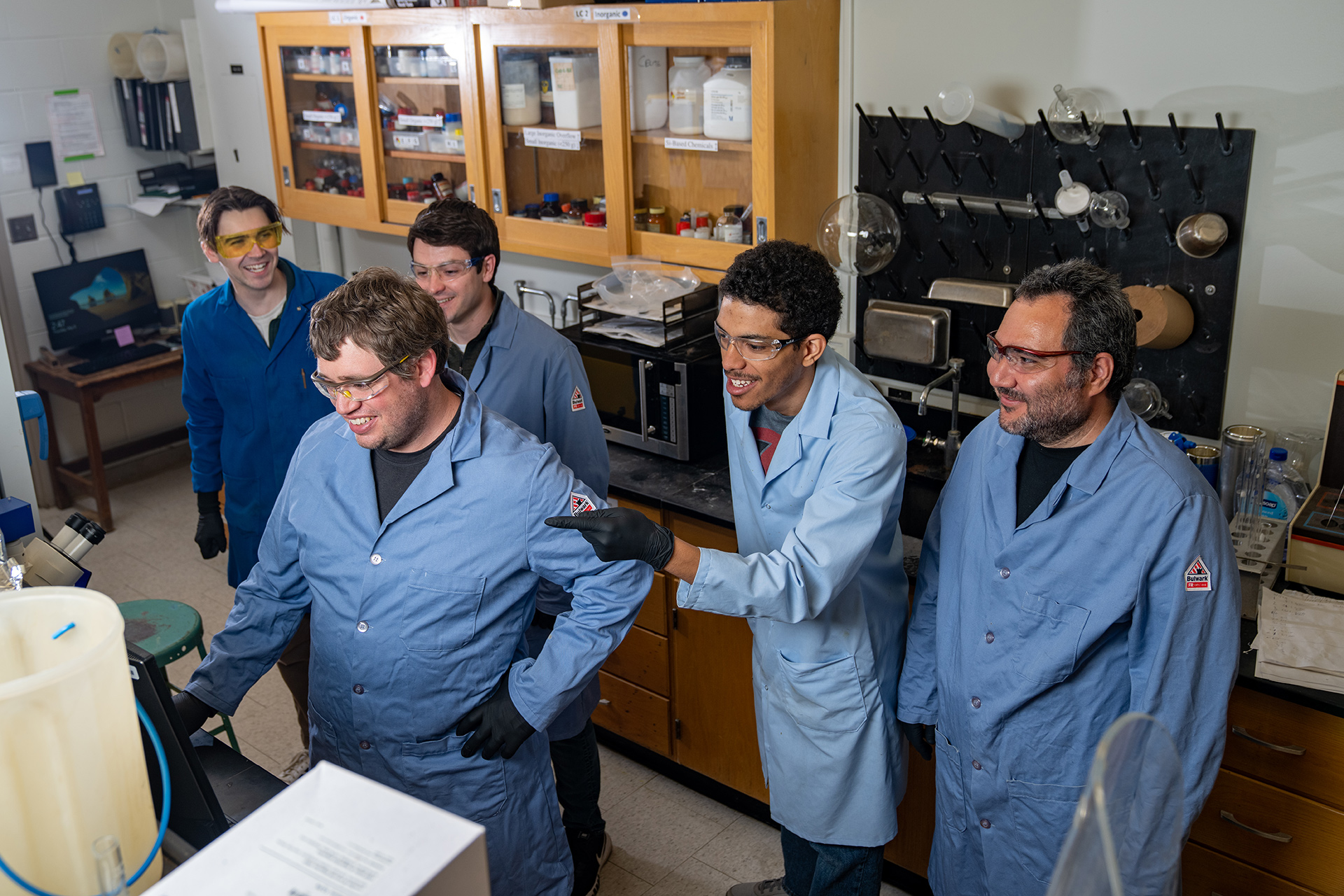 Five scientists work together in a lab