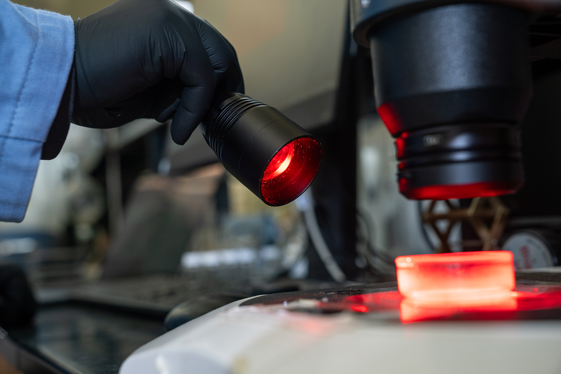 A red light is shined on a lab sample
