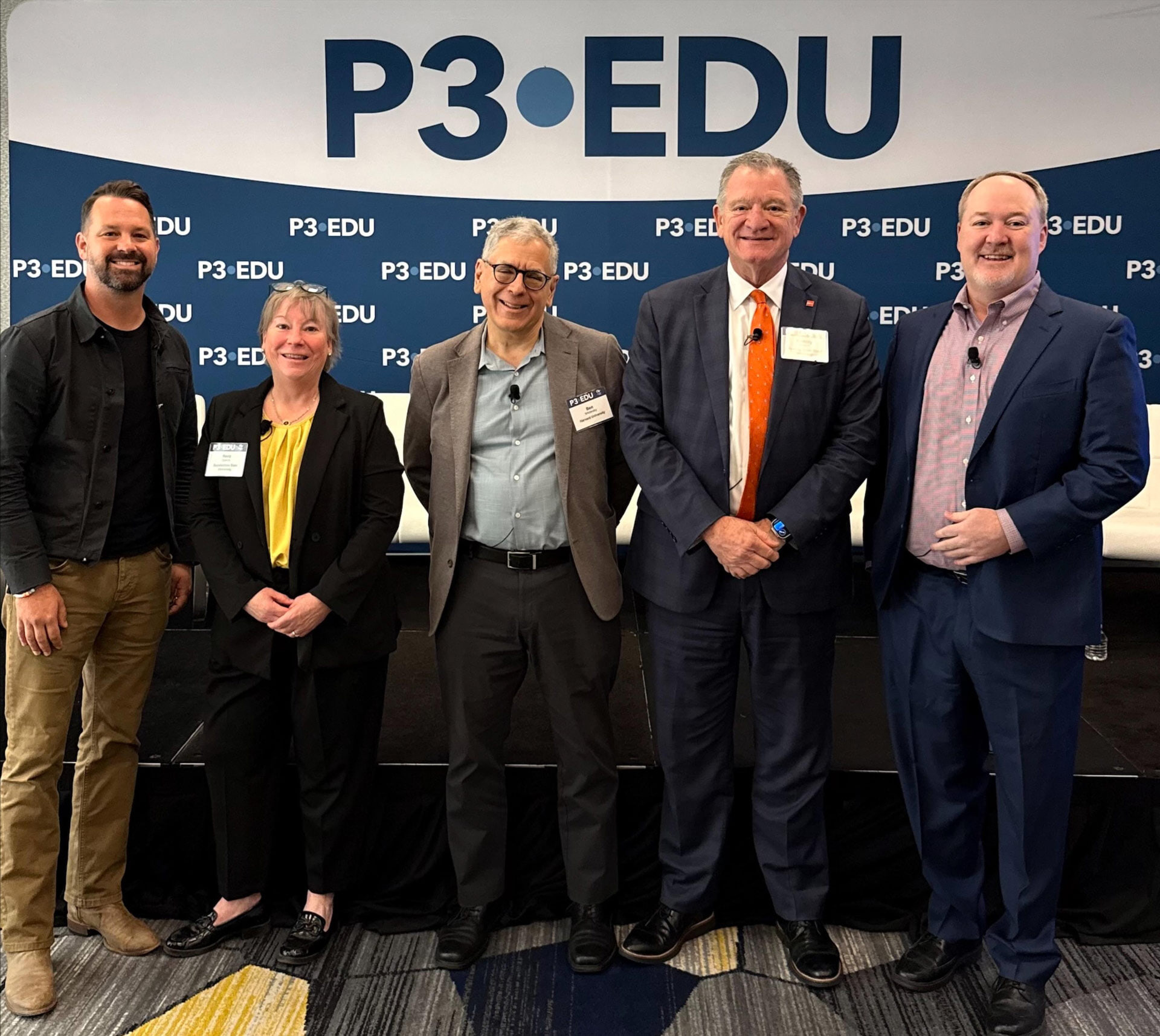 A group of people pose in front of a P3 EDU banner