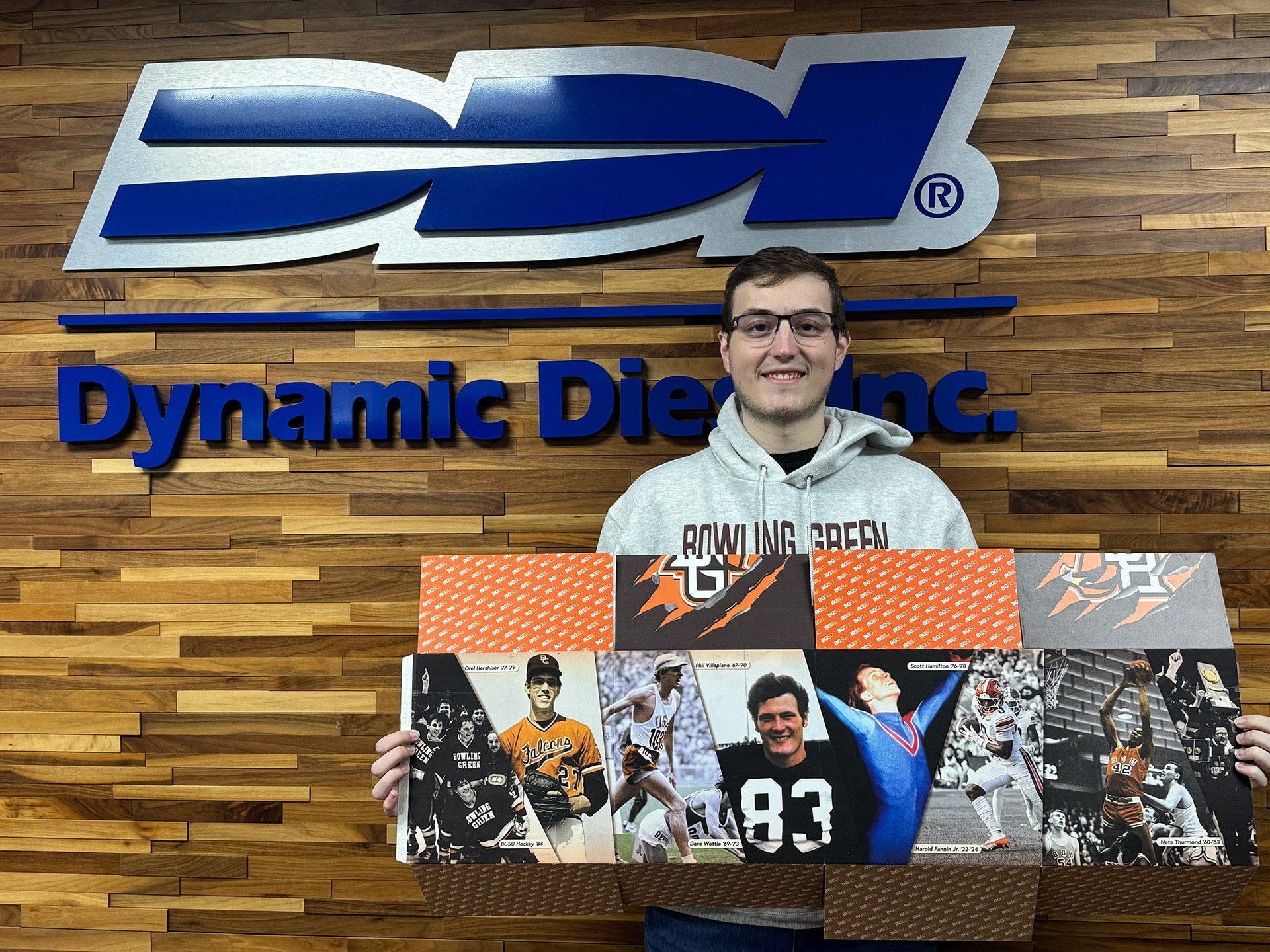 A person holds an intricately designed Bowling Green-branded box