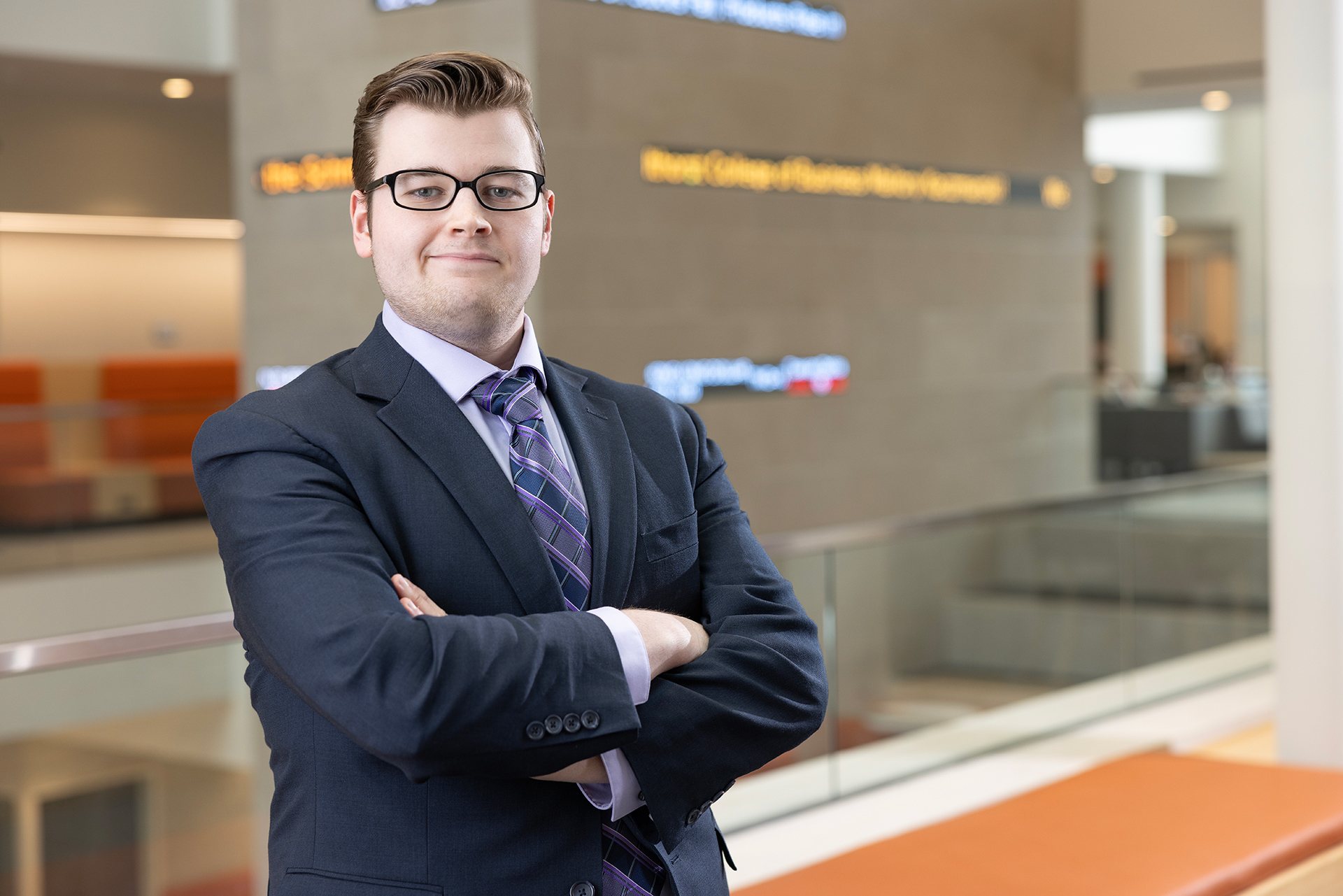 A man in a suit poses for a picture