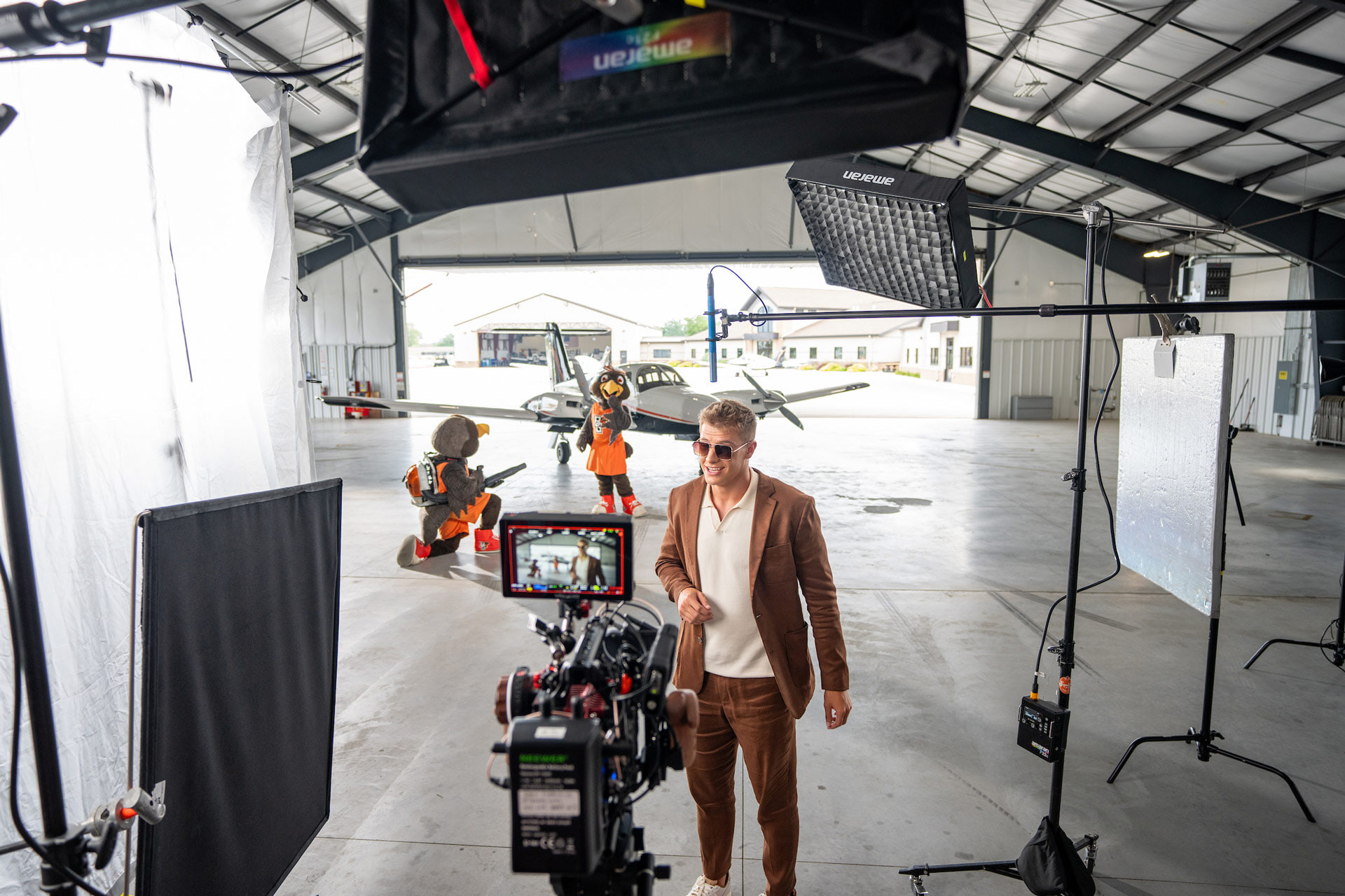 A man speaks into a camera on set. 