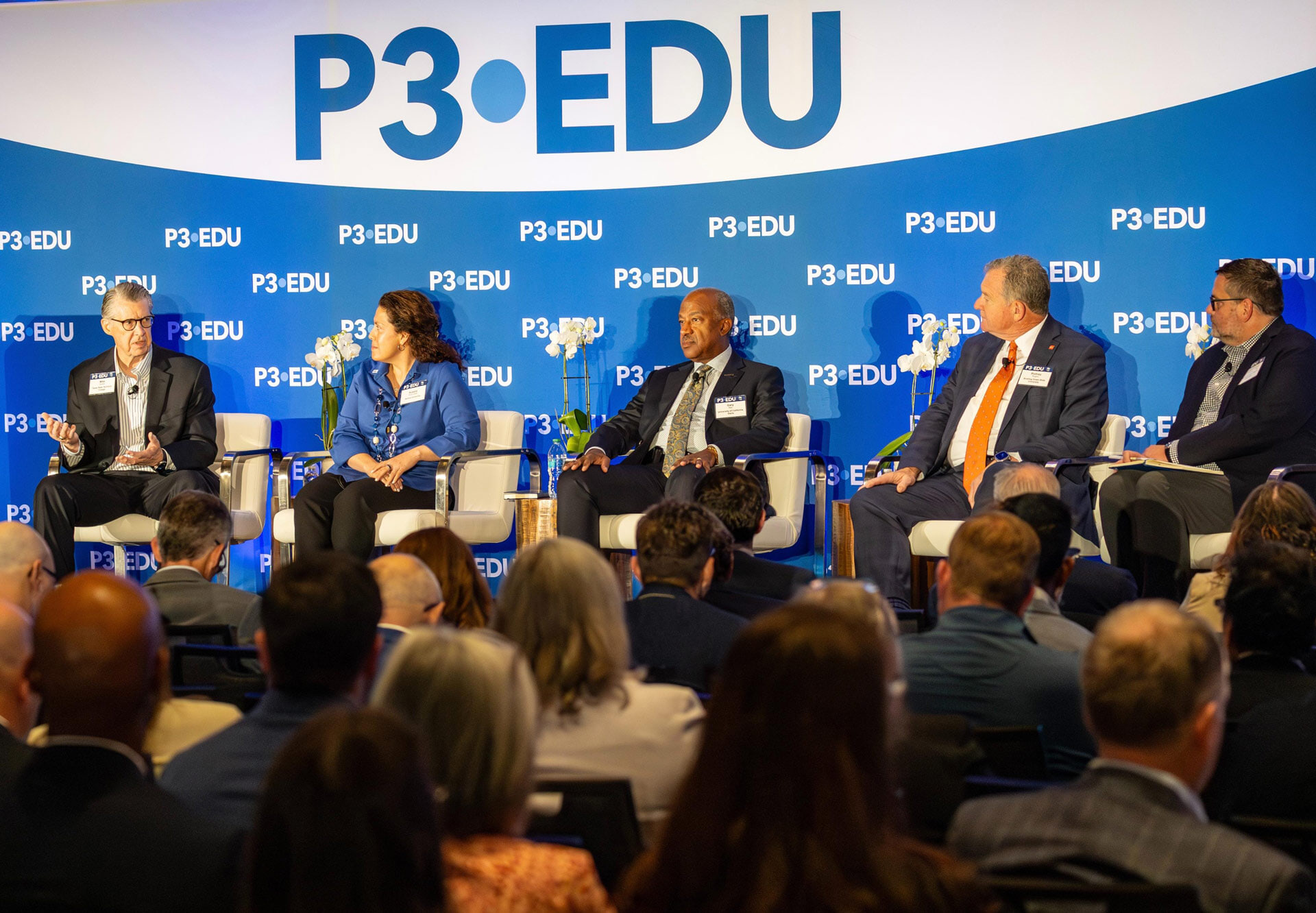 A panel of experts present on a stage at the P3.EDU conference