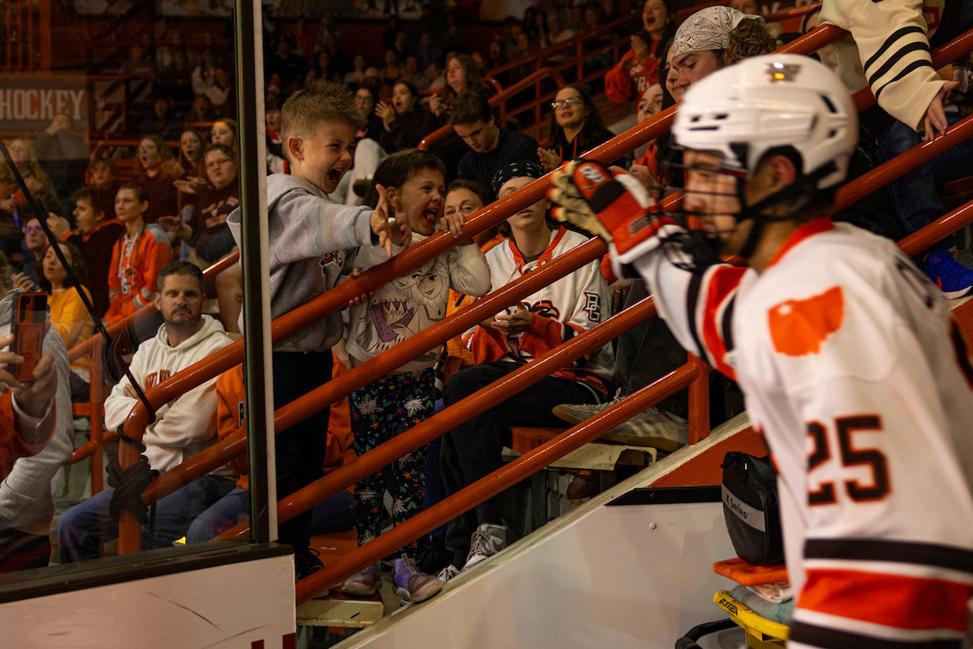 Falcon hockey players give young fans high fives