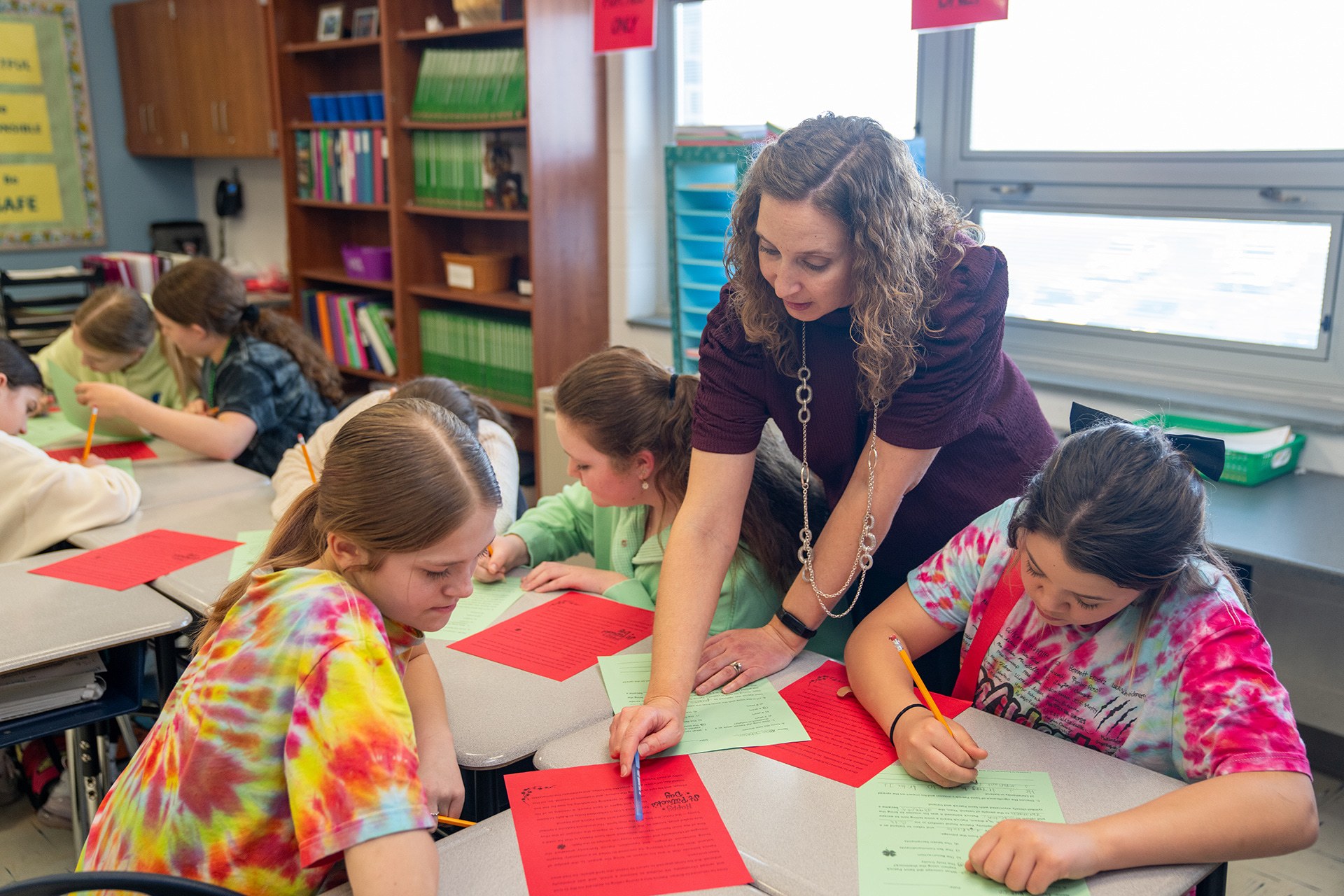 A teacher speaks to a group of students.