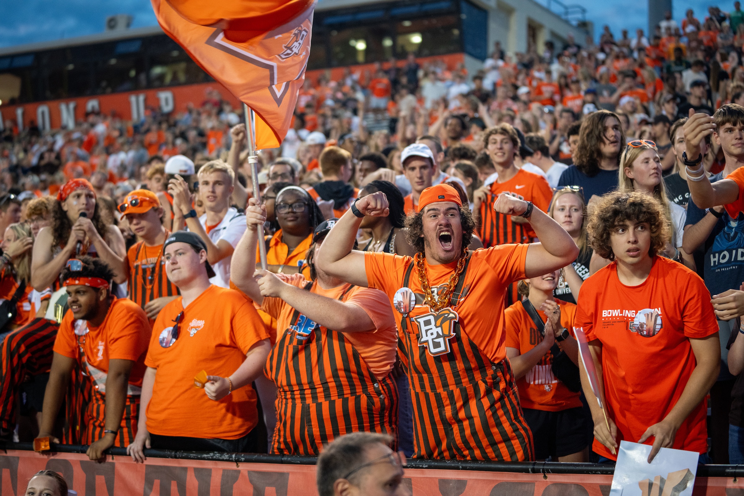 Fans celebrate at a football game.