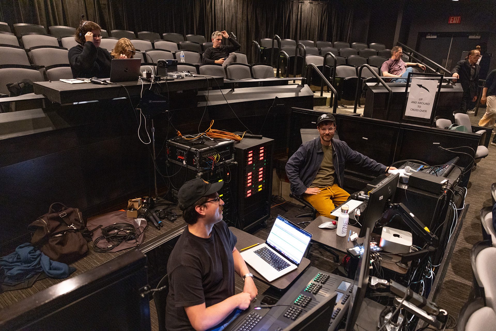 Sound engineers work at a sound board.