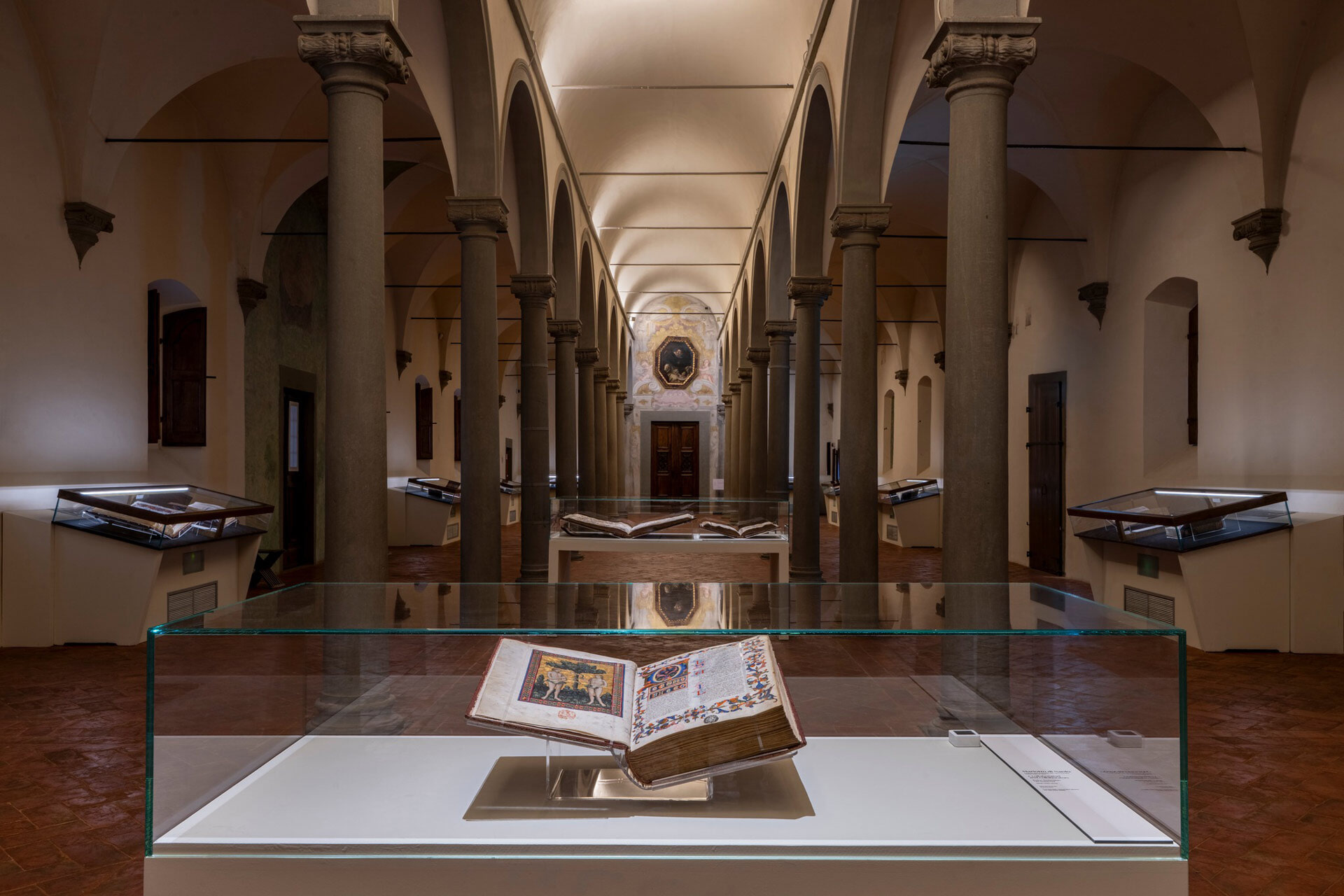 A book is seen in a display case inside of the Library of San Marco