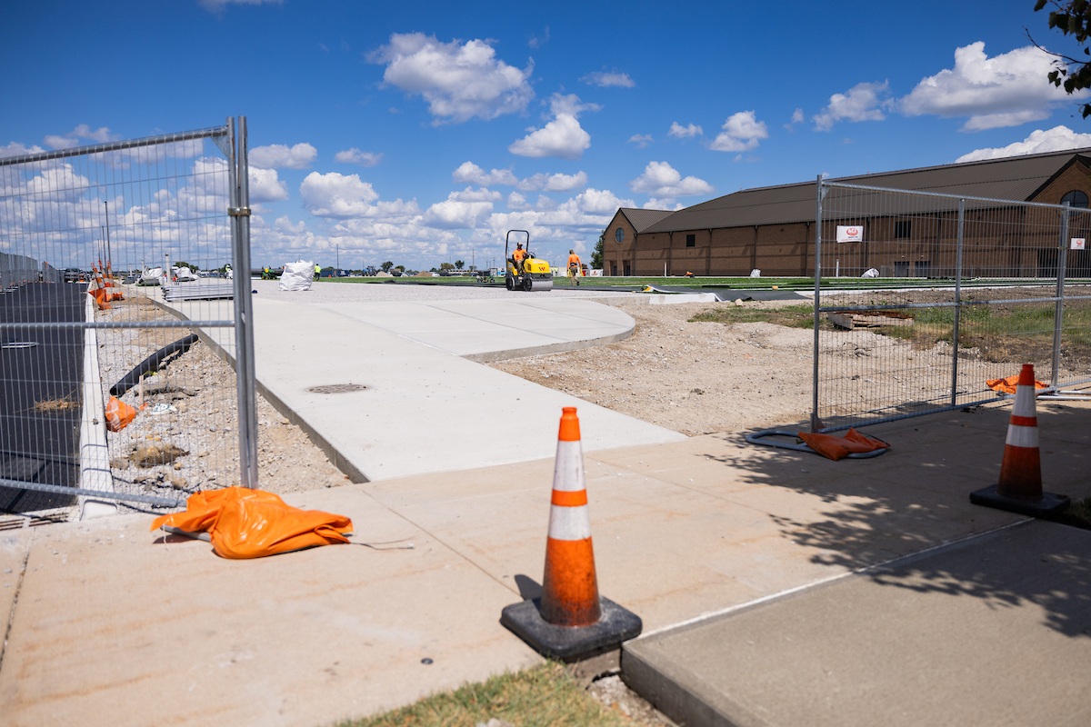Construction crews working on a turf field