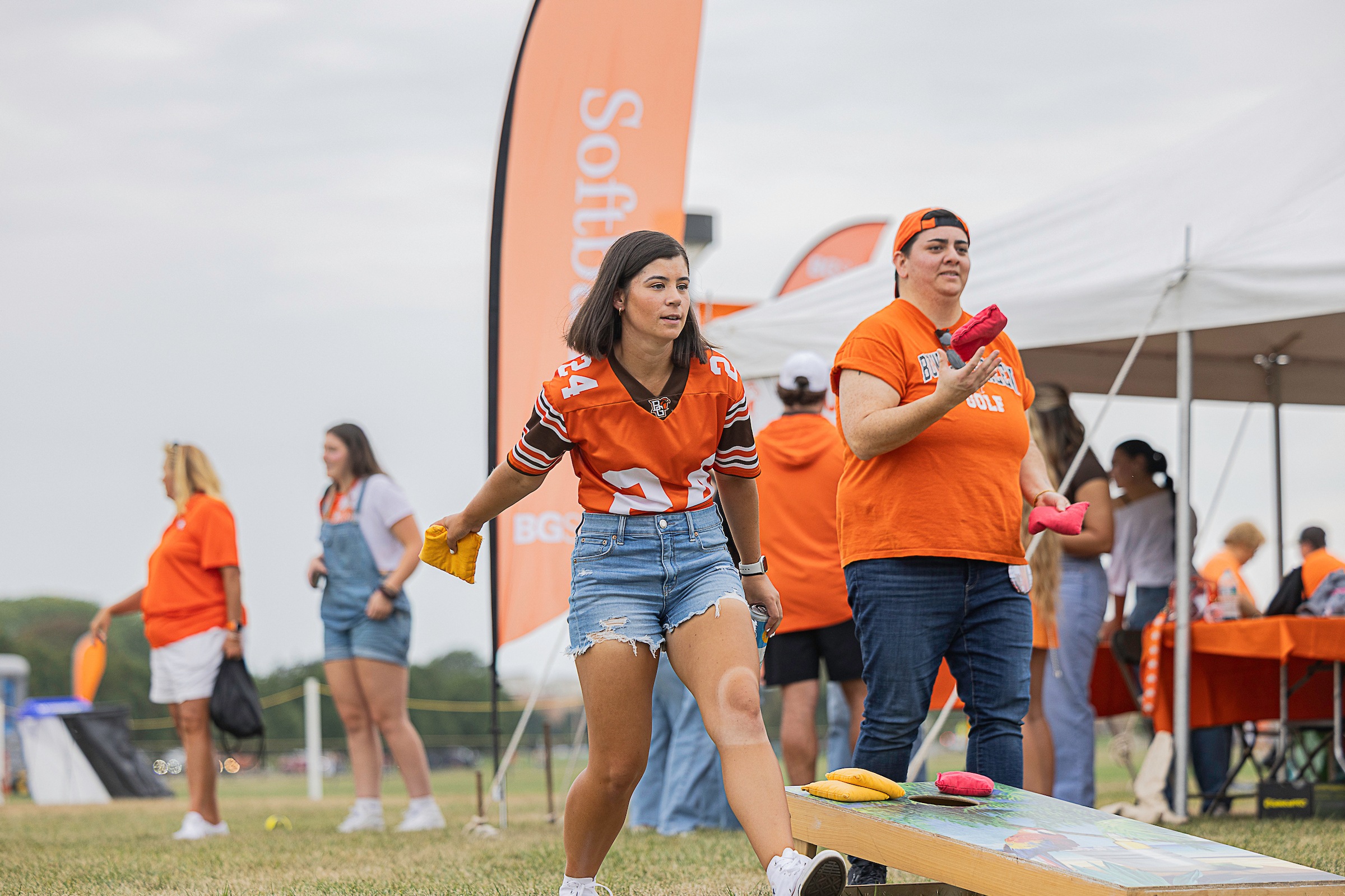 A person plays cornhole