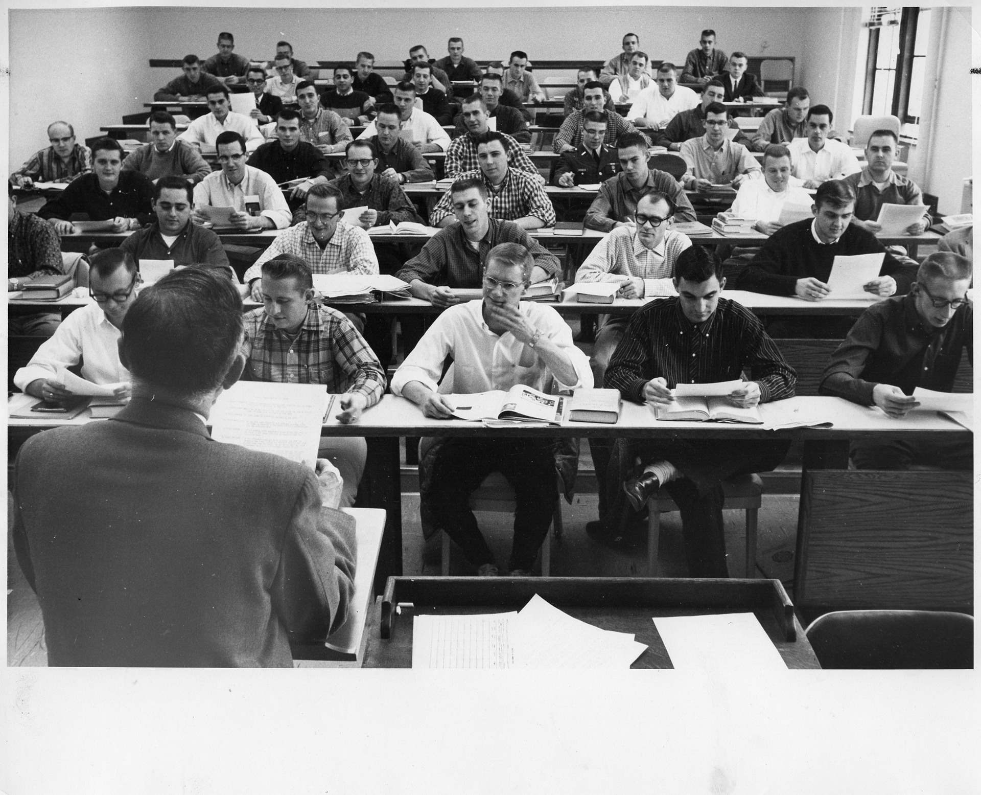 A group of administrators sit around a desk.