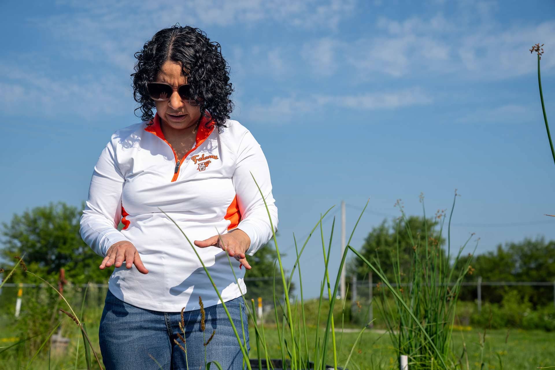 A scientist examines a plant.