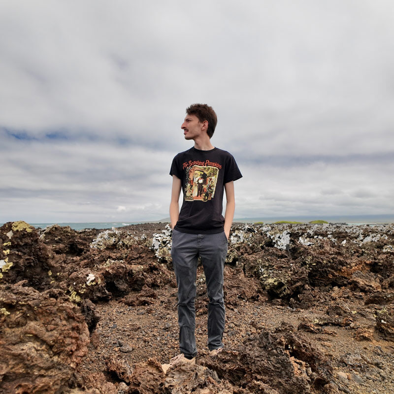 A person poses for a picture in the Glápagos Islands