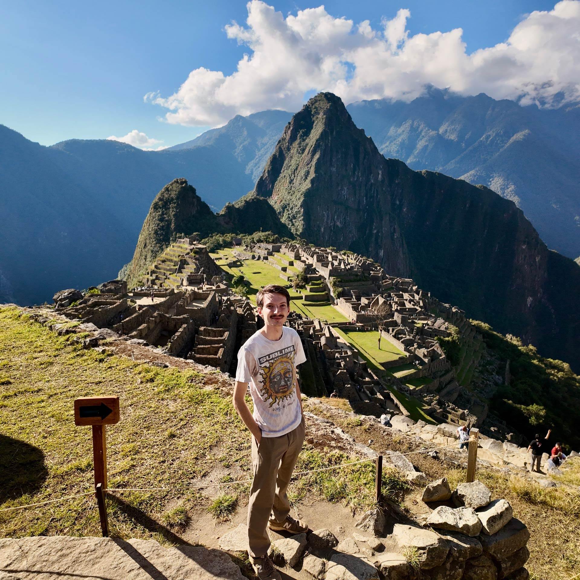 A man stands for a picture at Manchu PIcchu, Peru