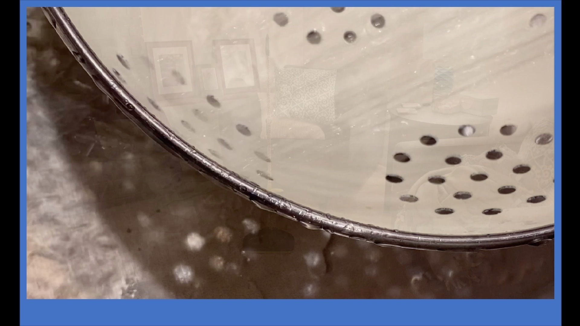 close-up photo of interior of a colander and faded reflections of a room interior]