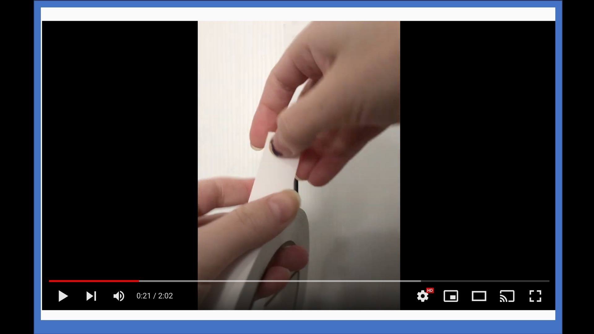 close-up photo of hands pulling on a roll of white tape]