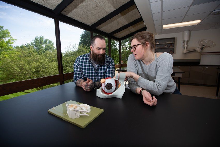 A professor and student work together in a classroom