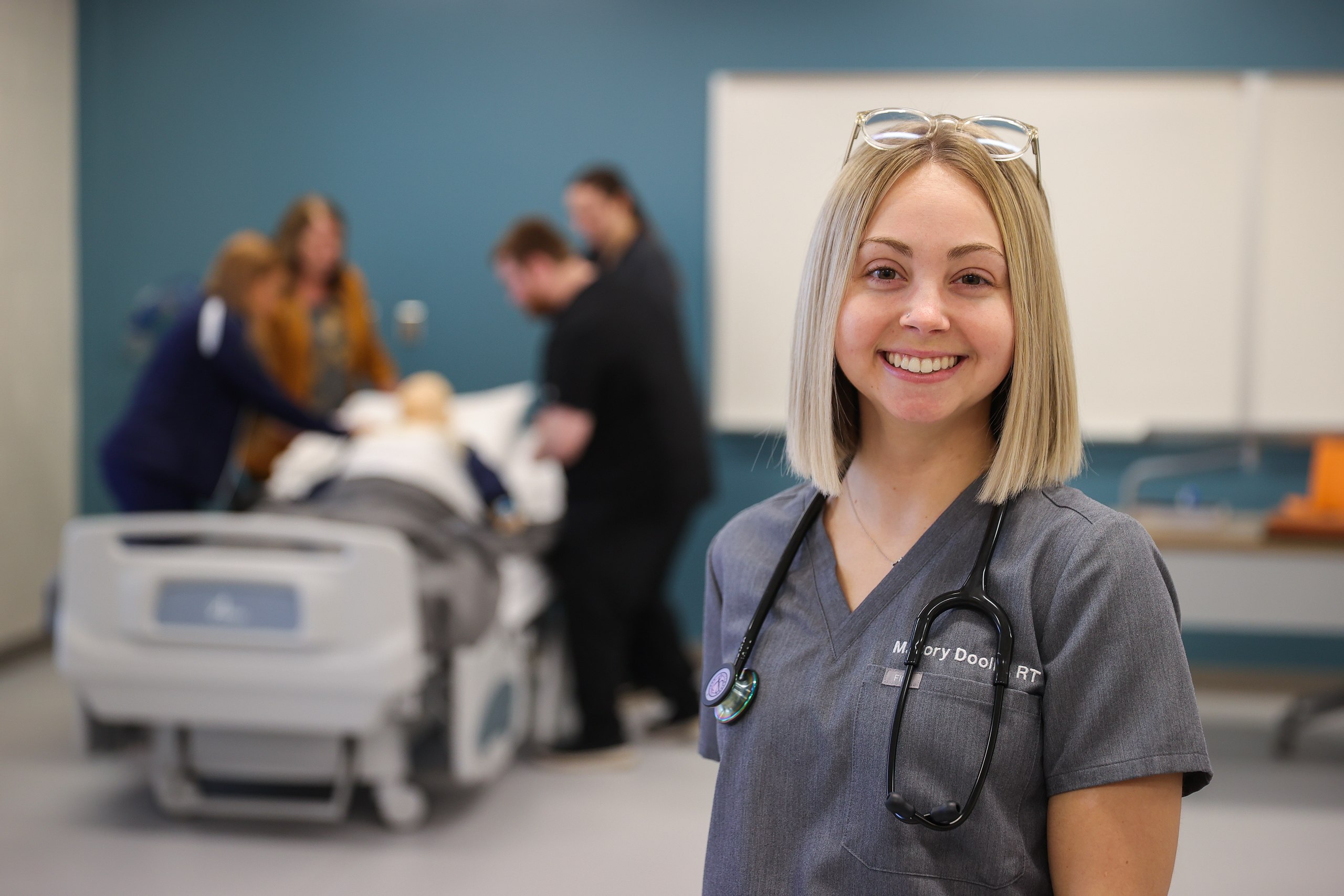 Two students learning to use life support ventilators