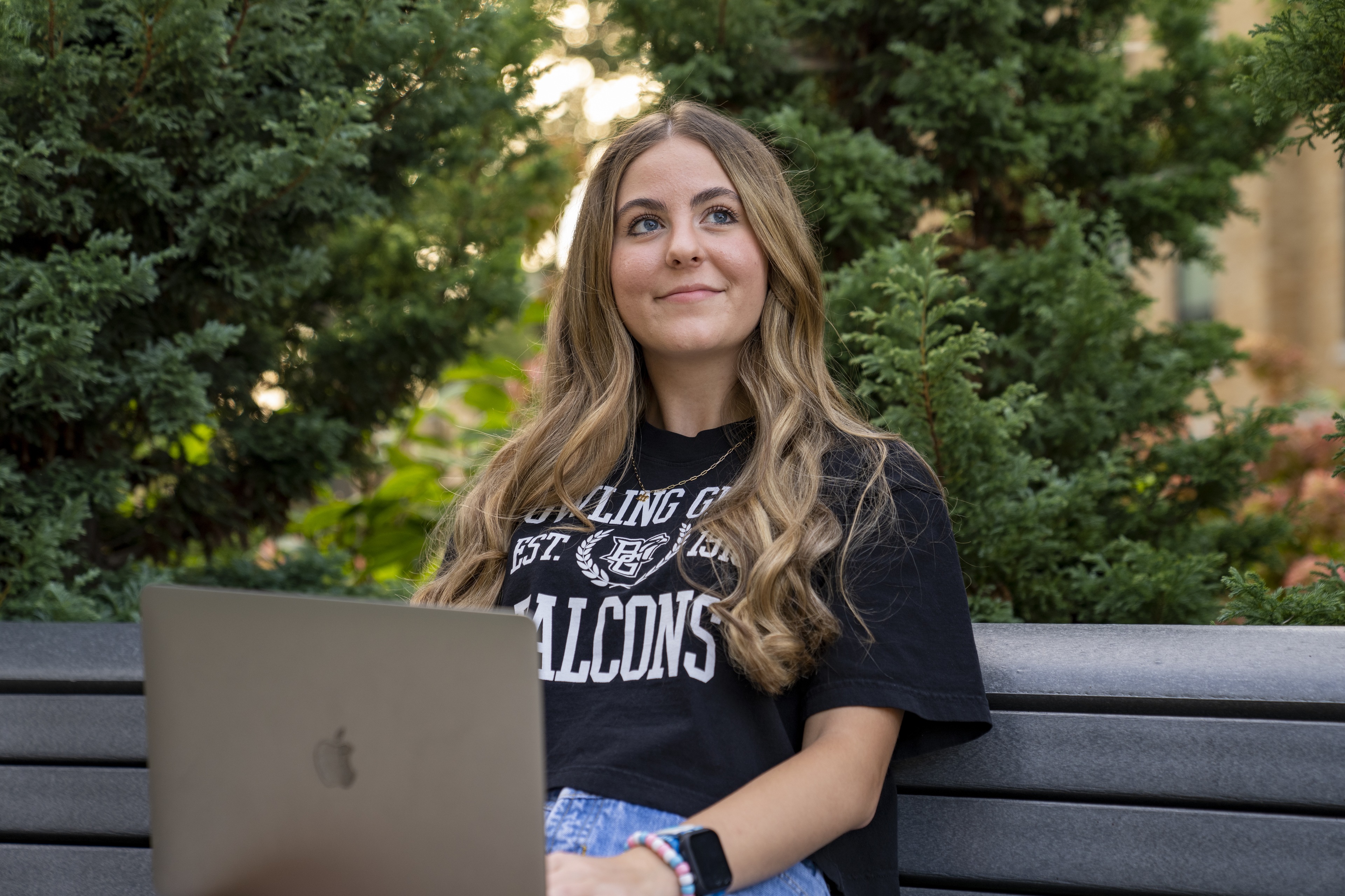 student smiling with laptop